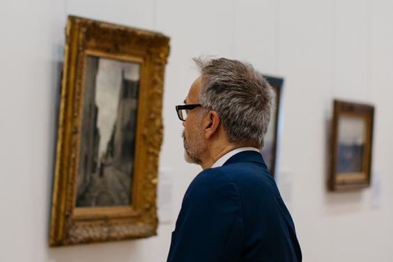 Man looking at a painting in the Millennium Wing of the National Gallery of Ireland.