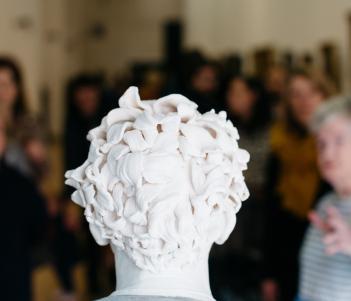 A tour group from behind the bust of Gerry Hynes by Vera Klute. © National Gallery of Ireland. 