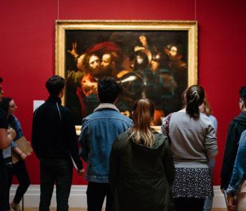 Visitors in front of the Taking of Christ in the exhibition Beyond Caravaggio. © National Gallery of Ireland.