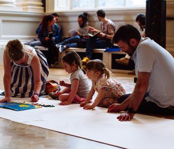 A family drawing together on the floor of the Shaw Room of the National Gallery of Ireland on National Drawing Day 2018.