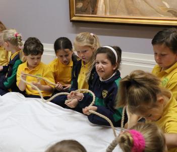 Group of school children taking part in an interactive tour of the Sorolla exhibition