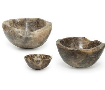Three brown-hued bowls carved out of rock salt