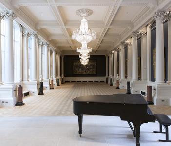 View of the Shaw Room at the National Gallery of Ireland, with a piano in the foreground.