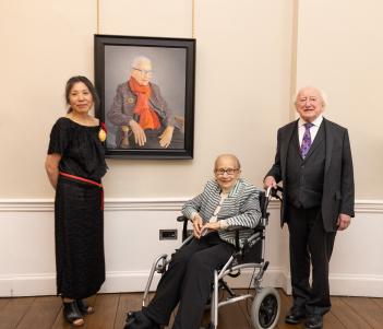 Artist Miseon Lee, former Supreme Court Judge Catherine McGuinness, President Michael D. Higgins pose next to a portrait of Catherine McGuinnessand 