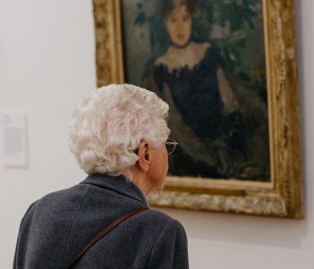 A visitor looking at Berthe Morisot's painting Corsage Noir in the Millennium Wing of the National Gallery of Ireland.