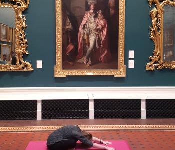 A yoga class taking place in the Grand Gallery of the National Gallery of Ireland.