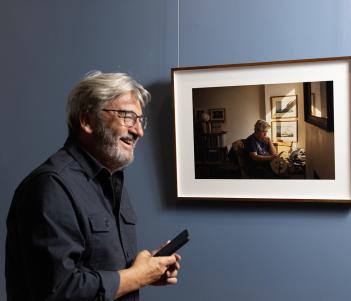 Fergal Keane smiling in front of his portrait by artist Enda Bowe in the National Gallery of Ireland