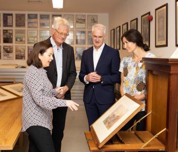 Gallery staff show Grant Thornton representative a watercolour by J.M.W. Turner