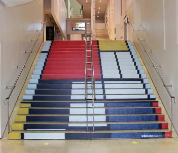 Staircase covered in a image of squares in primary colours by Mondrian.