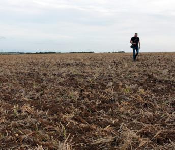 Artist Garrett Phelan recording sound in the field where the Battle of the Somme took place.