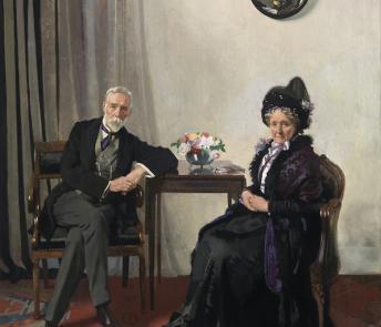Double portrait in oils of an older man and woman seated at a small table in an interior, with a convex mirror hanging above them on the wall reflecting the artist at work..