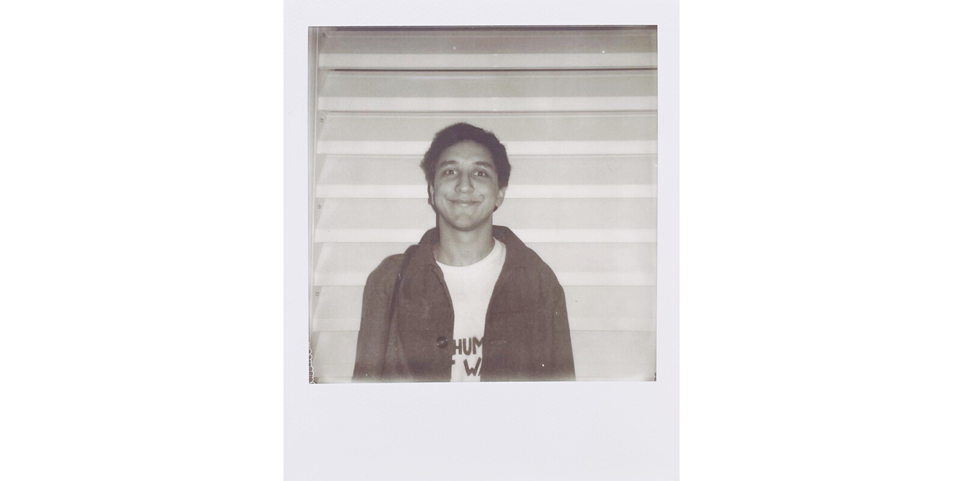 Polaroid photograph of a young male figure with an animated expression
